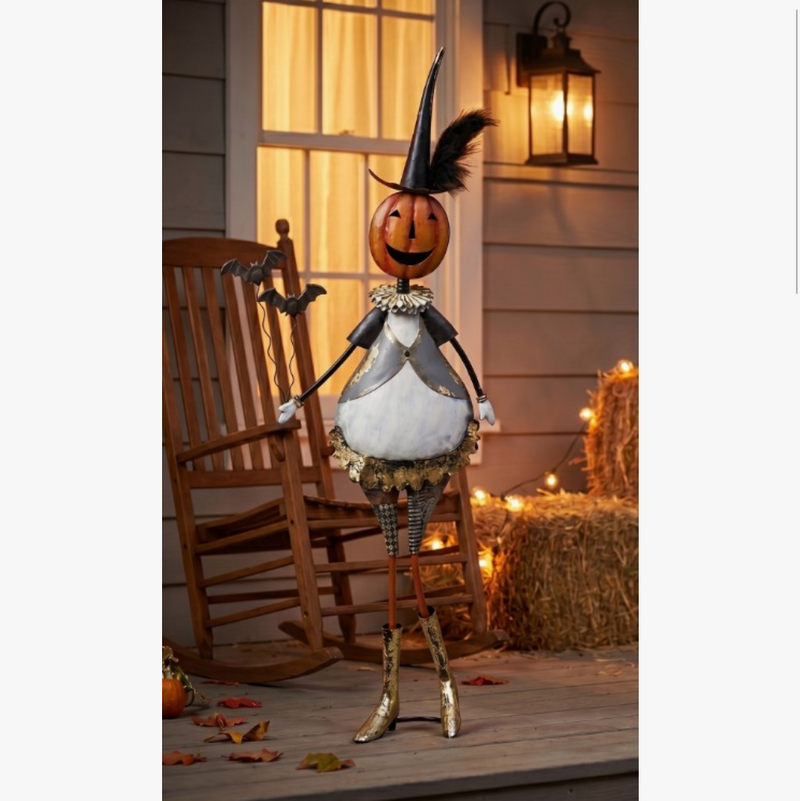 Halloween-themed decorative figure on a porch with rocking chair and lanterns.