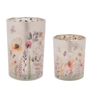 Two floral-patterned candle holders on a white background