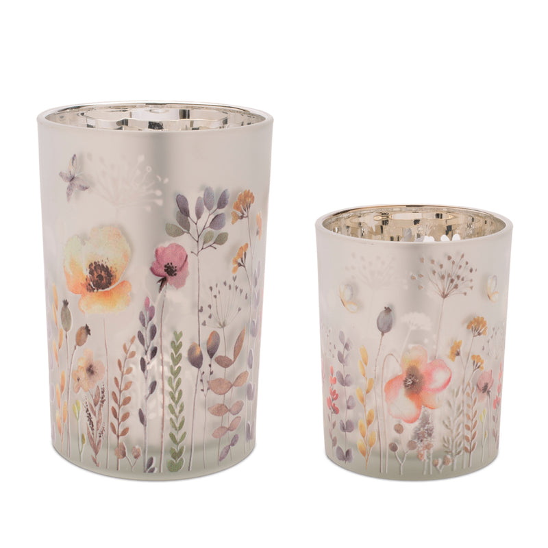 Two floral-patterned candle holders on a white background