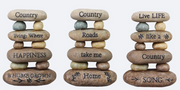 Three stone stacks with engraved phrases on a white background