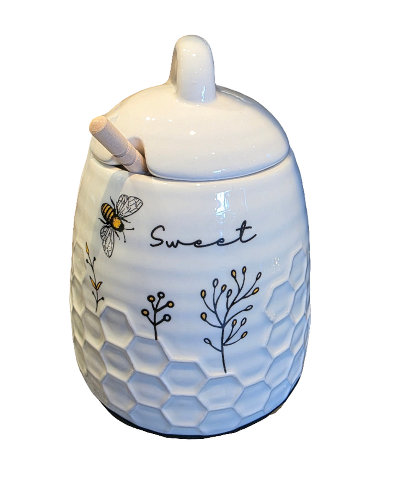 White ceramic jar with honeycomb design, bee, and 'sweet' text on a white background