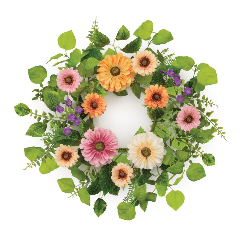Floral wreath with colorful flowers and green leaves on a white background