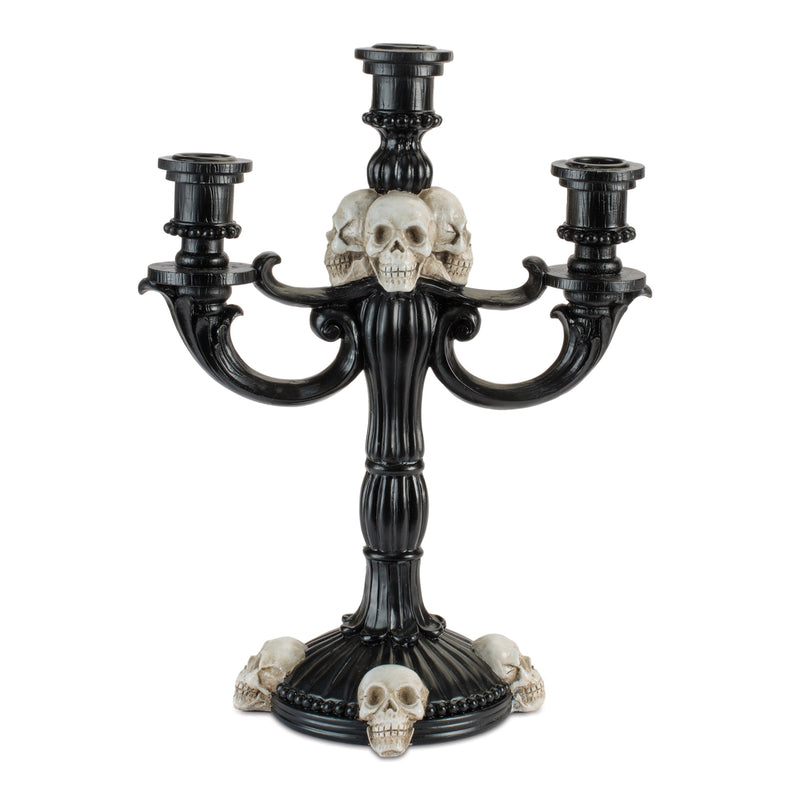 Black candelabra with skull design on a white background