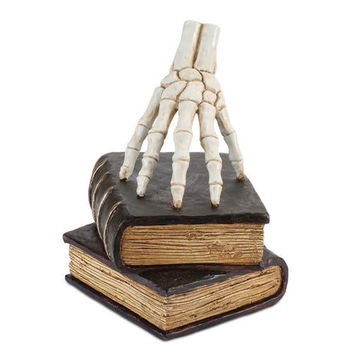 Skeleton hand emerging from a book on a white background