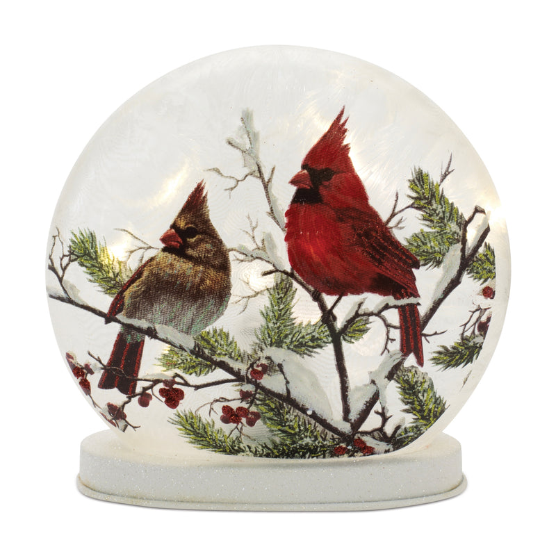 Decorative snow globe with cardinals on a branch inside