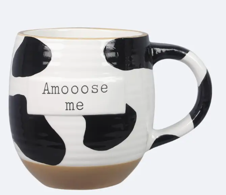 Cow print mug with 'Amooose me' text on a white background