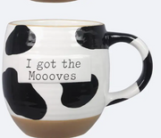 Cow print mug with 'I got the Moooves' text on a white background