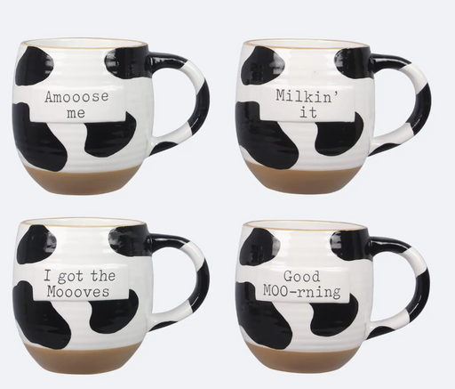 Set of four cow print mugs with humorous sayings on a white background