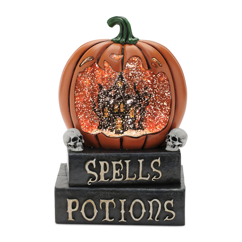 Decorative pumpkin with a witch inside, sitting on a base with 'Spells Potions' text, on a white background.