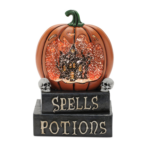 Decorative pumpkin with a witch inside, sitting on a base with 'Spells Potions' text, on a white background.