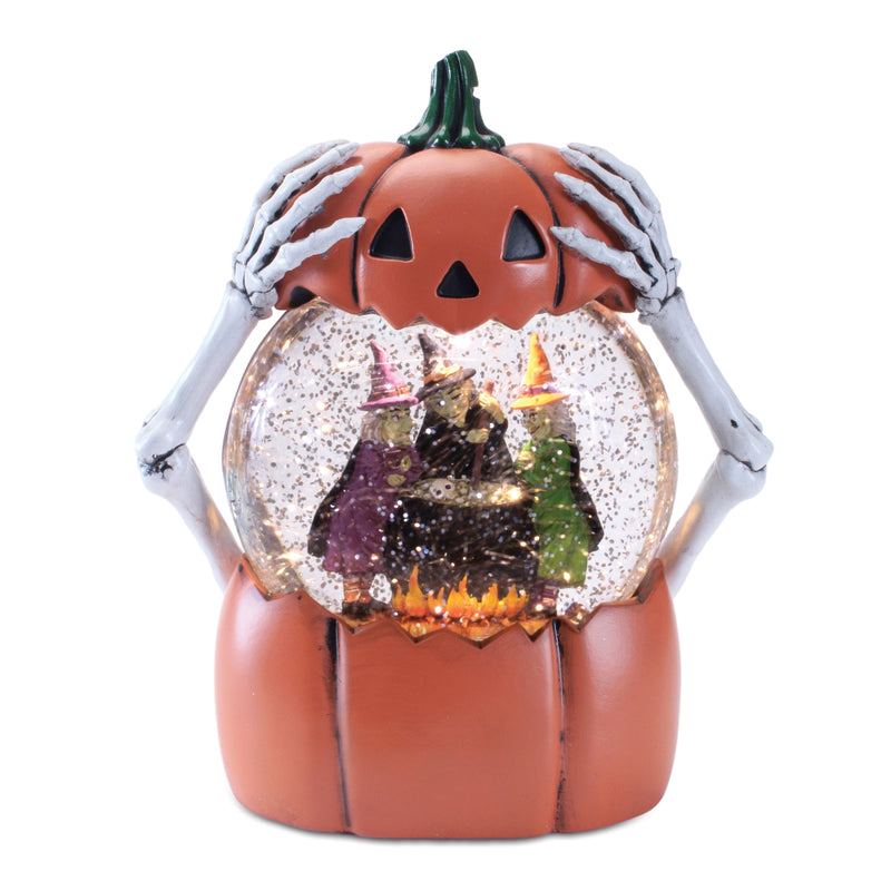 Halloween-themed snow globe with a pumpkin base, skeleton hands, and a witch inside.