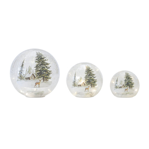 Set of three decorative glass spheres with Christmas scenes featuring trees and deer on a white background.