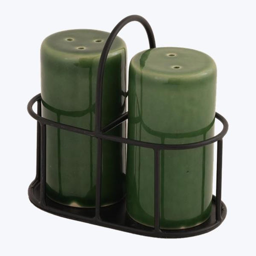 Two green salt and pepper shakers in a black holder on a white background