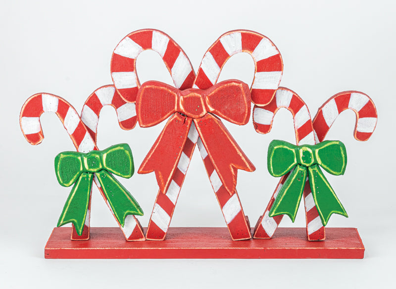 Decorative candy canes with bows on a white background