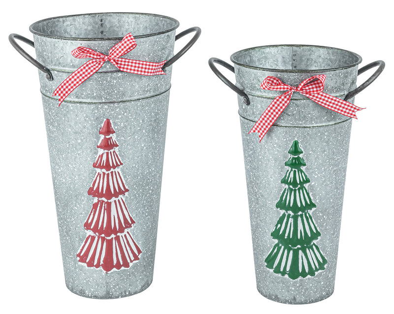 Two galvanized metal bucket planters with wire handles, decorated with red and green Christmas tree graphics and red gingham ribbon bows, shown on a white background.