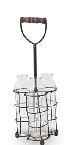 Metal bottle carrier with four glass bottles on a white background