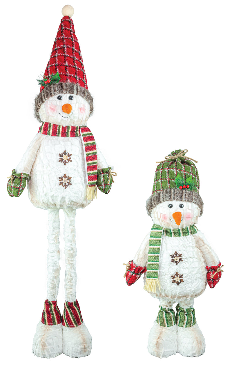 Two plush snowman decorations on a white background, one tall and one short, both wearing plaid hats, scarves, mittens, and boots in red, green, and white.