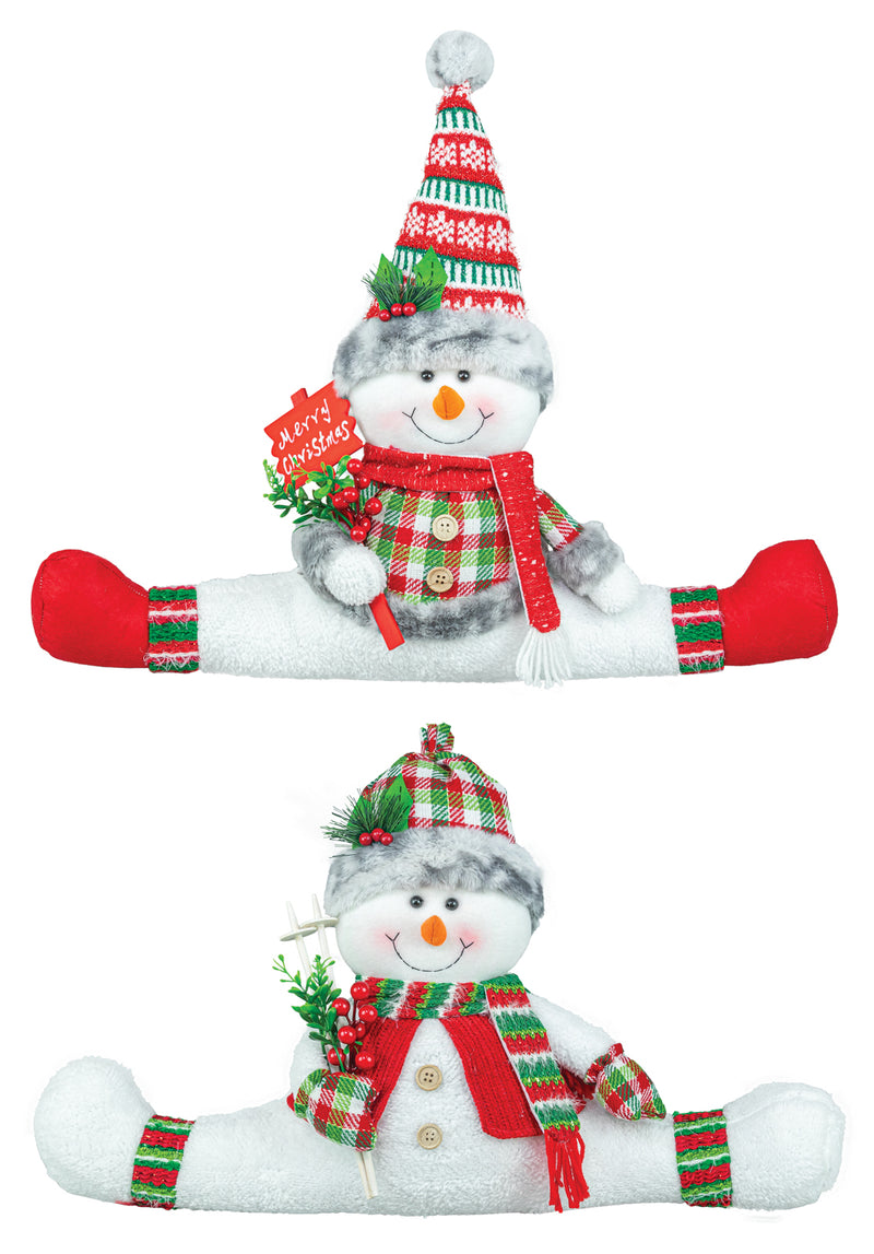 Two views of a plush snowman Christmas decoration sitting in a split position, wearing a red and green plaid hat, scarf, and cuffs, with a red 'Merry Christmas' sign.