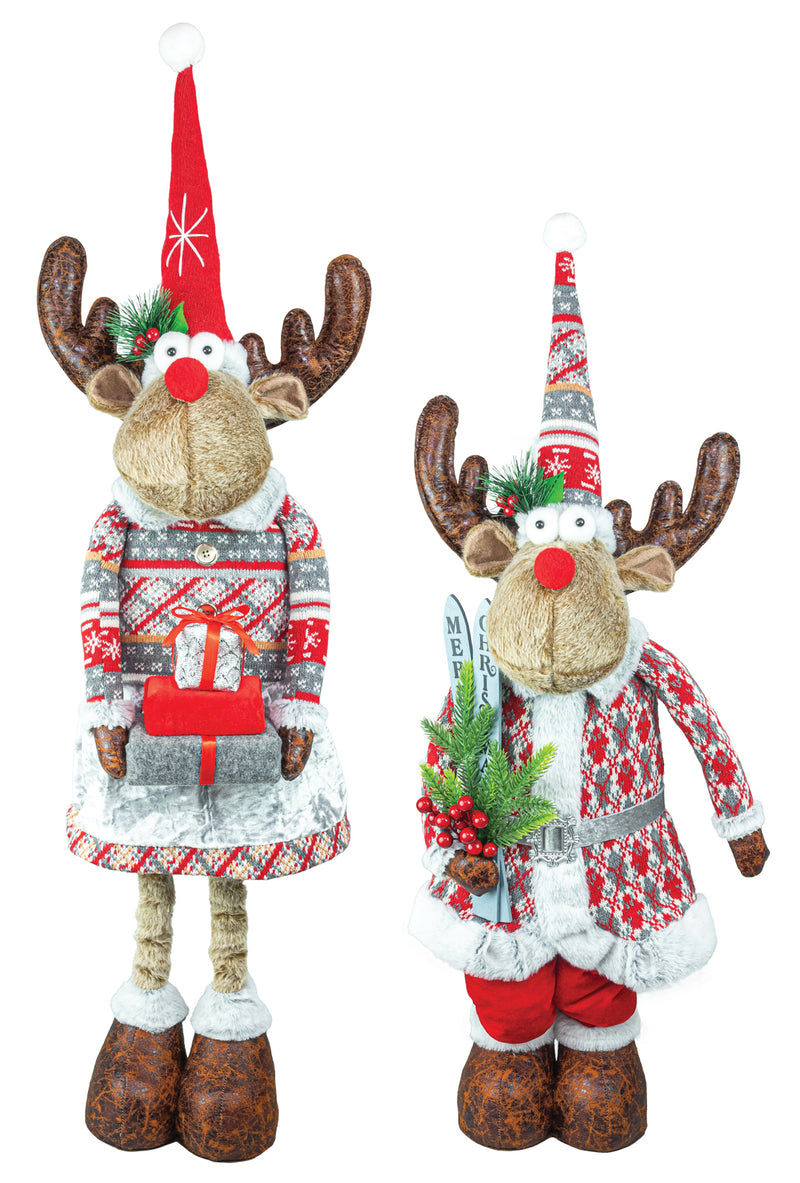 Two Christmas reindeer figurines wearing festive holiday sweaters and hats, standing against a plain white background.