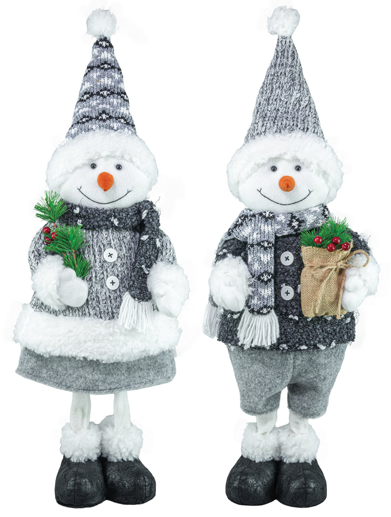 Two festive snowman decorations standing side by side on a white background. One holds a small green pine sprig, and the other holds a brown burlap-wrapped gift with red berries.