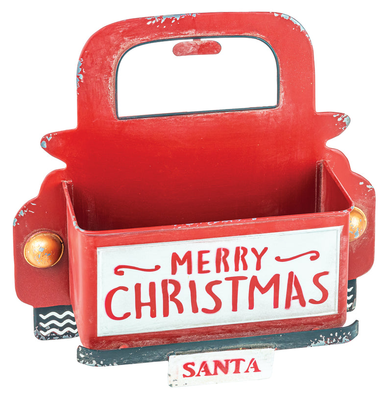 A red metal holiday gift basket shaped like a vintage truck bed with a handle, decorated with 'MERRY CHRISTMAS' on the front and a small 'SANTA' sign below, shown on a white background.