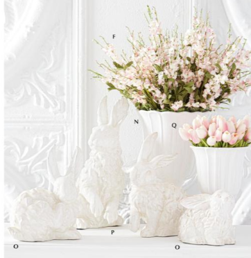 Decorative white vases with floral arrangements on a textured white background