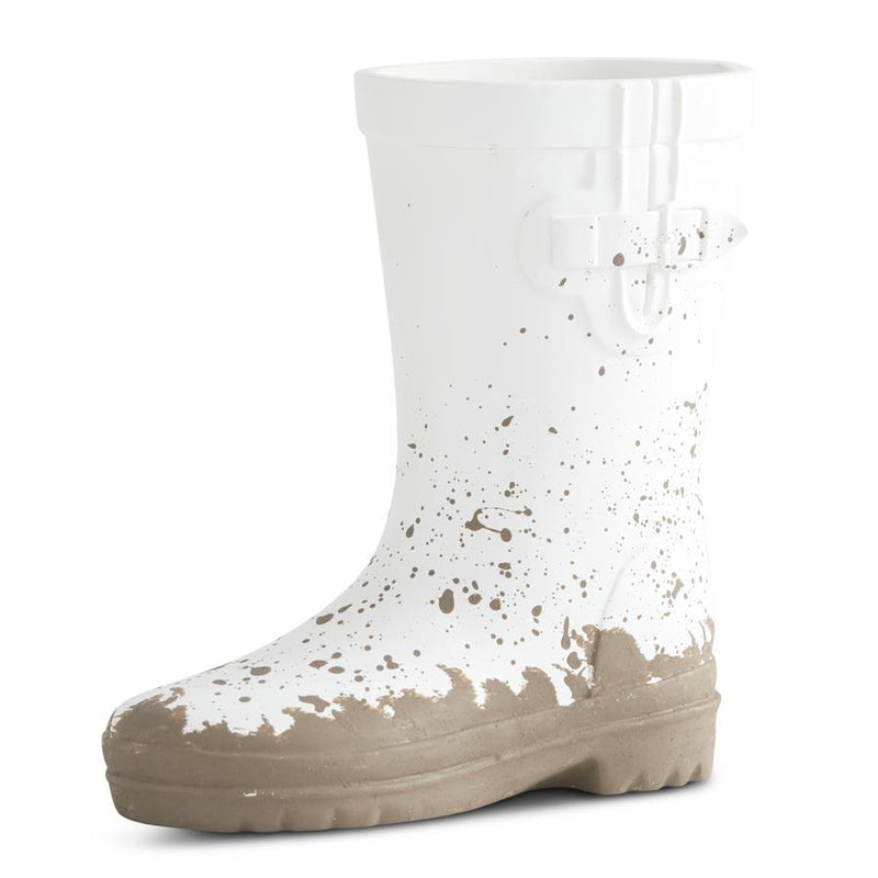 White rain boot with brown splashes on a white background