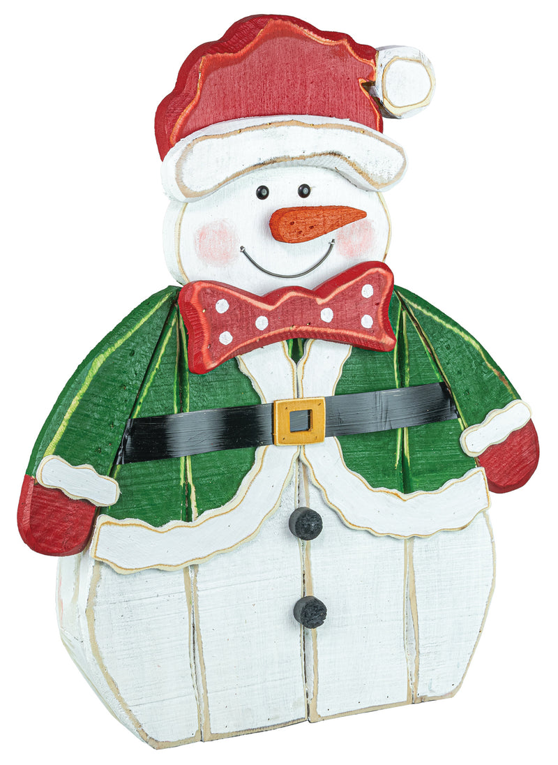 A painted wooden snowman Christmas decoration wearing a red Santa hat, green coat, red bow tie, black belt, and white pants, shown on a plain white background.
