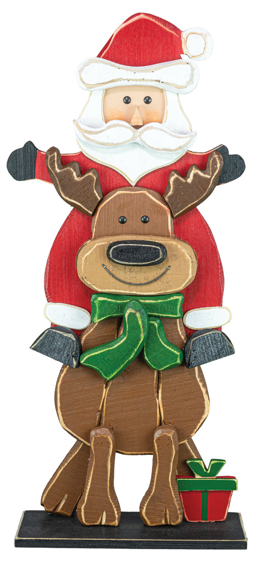 A festive wooden Christmas figurine featuring Santa Claus riding a brown reindeer, with a small red gift box at the base, shown against a plain white background.