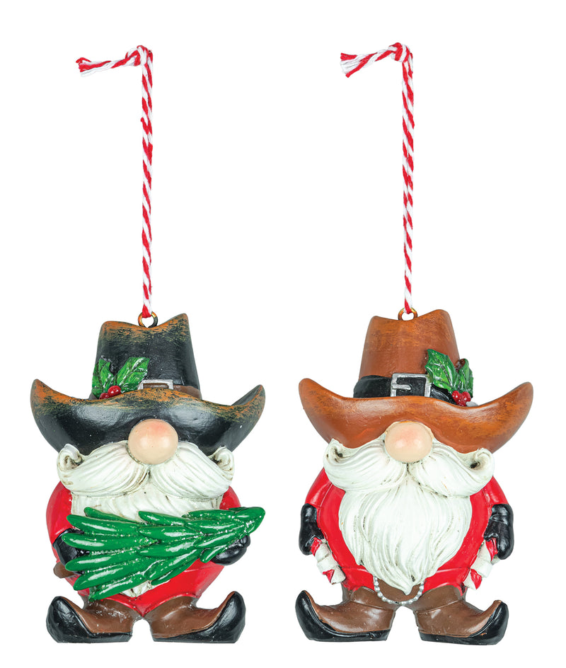 Two Christmas gnome ornaments hanging side by side on red-and-white twisted strings. One gnome wears a black hat and holds a green pine tree, and the other wears a brown hat with green holly accents.