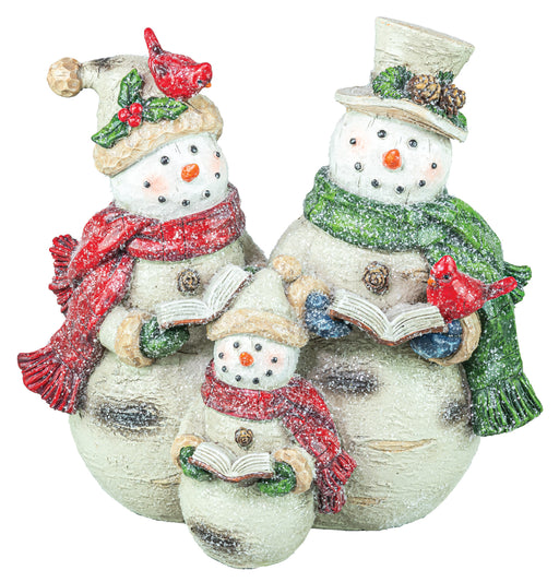 Three snowman figurines decorated for Christmas, including two larger snowmen and one smaller one, wearing winter hats, scarves, and holding open books, with red birds on their hats. The snowmen have a textured off-white finish with green, red, and blue accents.