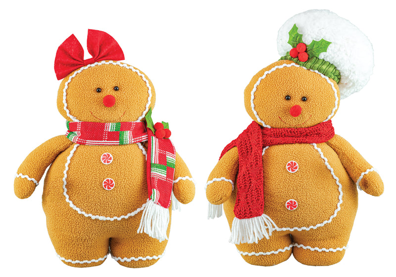 Two Christmas gingerbread doll plush toys side by side on a white background. One wears a red bow and a red, green, and white plaid scarf, while the other wears a white fluffy hat with a green holly leaf and red berry accent, along with a red scarf.