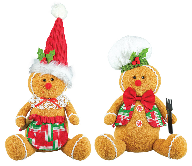 Two Christmas gingerbread doll decorations on a plain white background. One wears a red Santa hat with green holly accents and a red-and-green plaid dress, holding a candy cane.