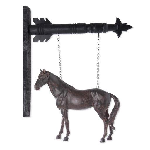 Decorative metal horse figure hanging from a black arrow-shaped hook on a white background