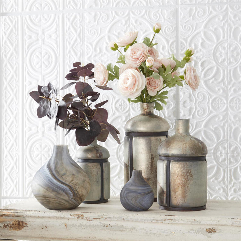 Decorative vases with flowers on a textured white wall background