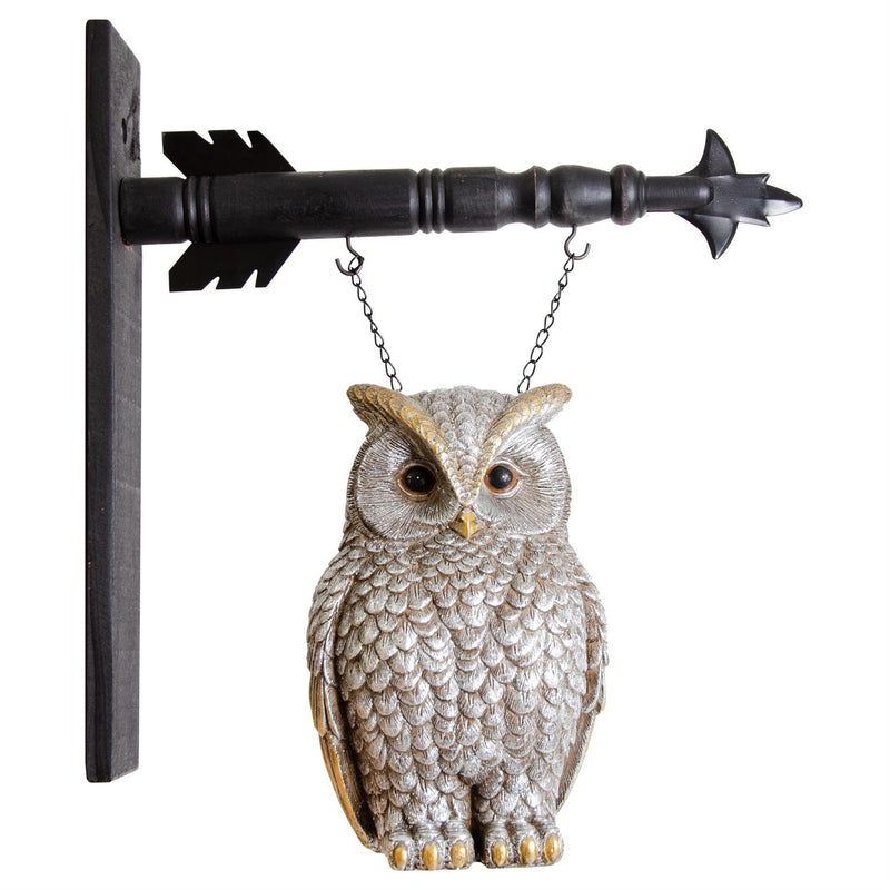 Decorative owl hanging from a metal arrow on a white background
