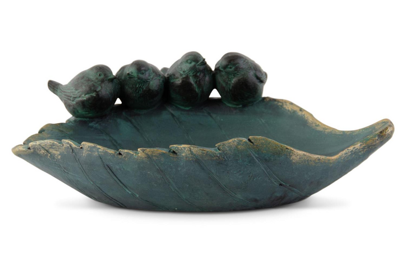 Decorative leaf-shaped bowl with three bird figurines on a white background