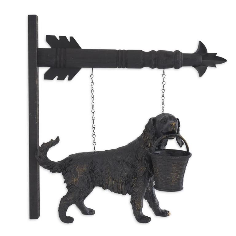 Decorative metal wall hanging of a dog with a bucket and an arrow.