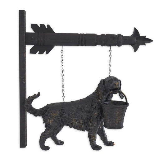 Decorative metal wall hanging of a dog with a bucket and an arrow.