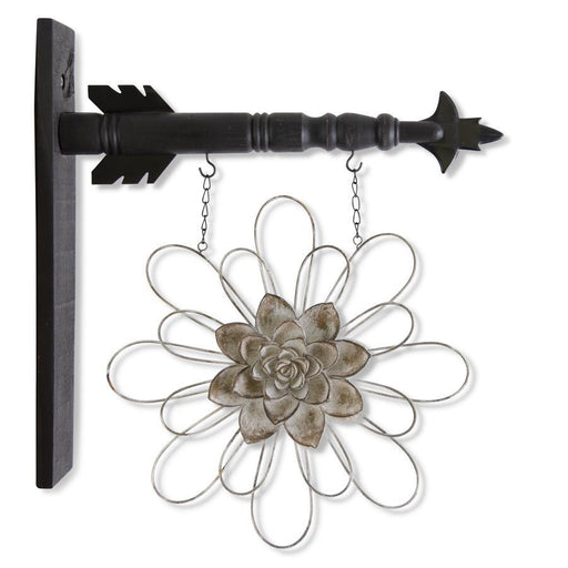 Decorative metal wall art with a flower design and black arrow-shaped bracket on a white background