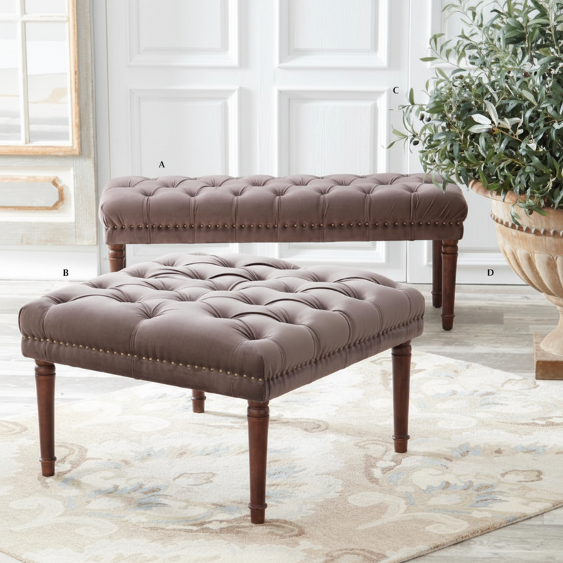 Brown tufted bench and ottoman set on a light wood floor with a plant in the background.