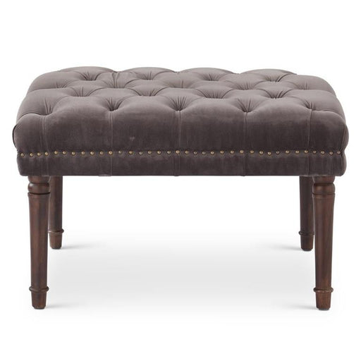 Gray tufted ottoman with wooden legs on a white background