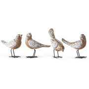 Four decorative bird figurines with floral patterns on a white background