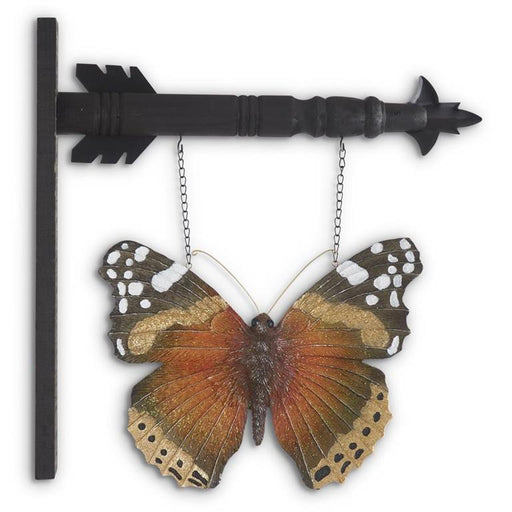 Butterfly-shaped decorative wall art with a black arrow-like structure on a white background