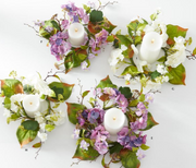 Decorative wreaths with candles and flowers on a white background