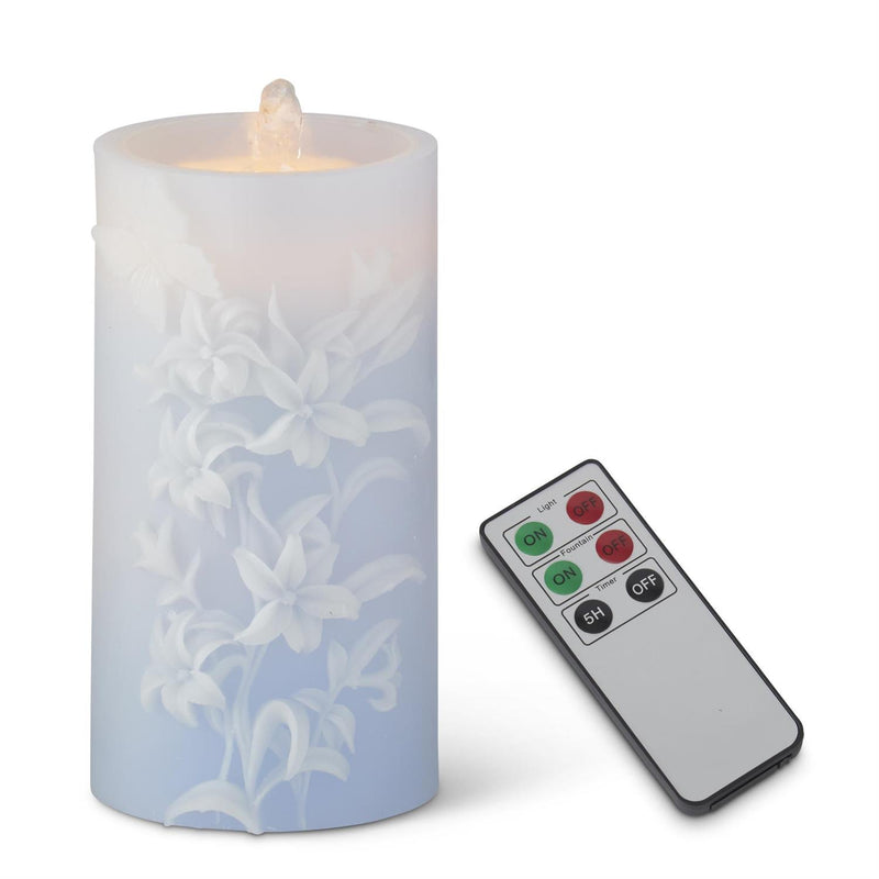 Flickering LED candle with floral design and remote control on a white background