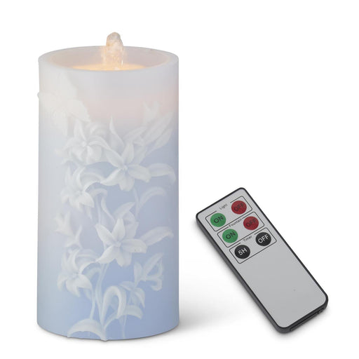 Flickering LED candle with floral design and remote control on a white background