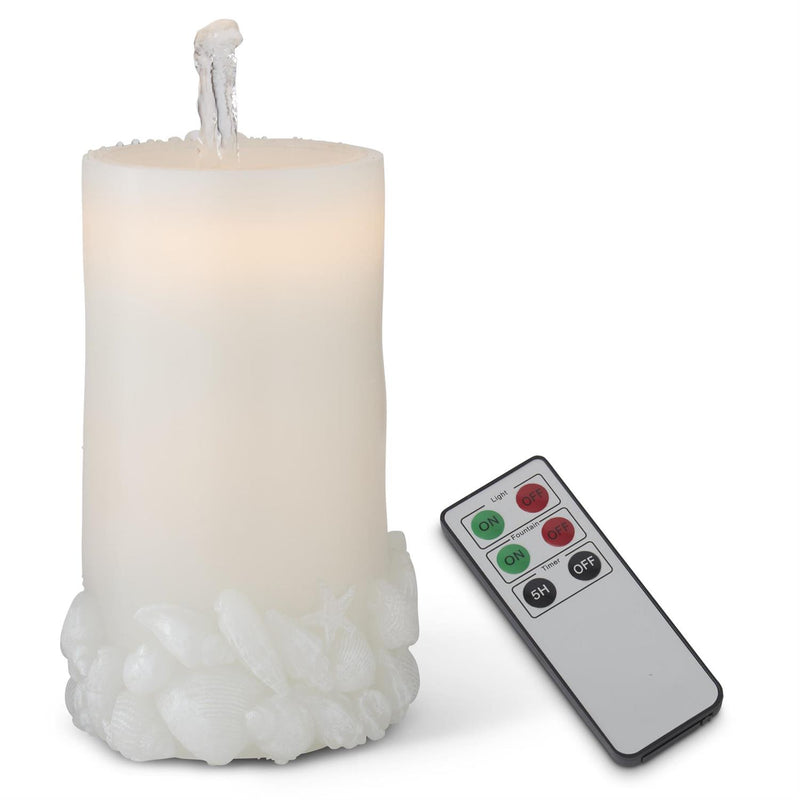 White candle with textured base and remote control on a white background