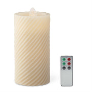 Decorative candle with wavy texture and remote control on a white background