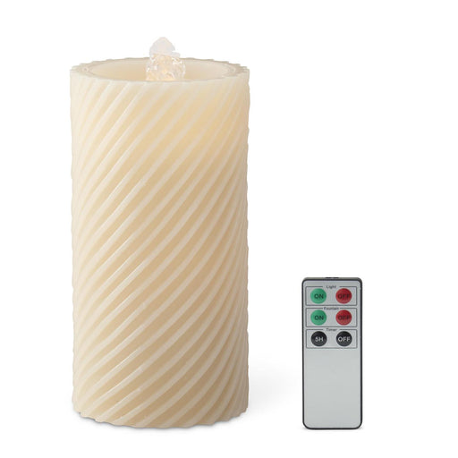 Decorative candle with wavy texture and remote control on a white background